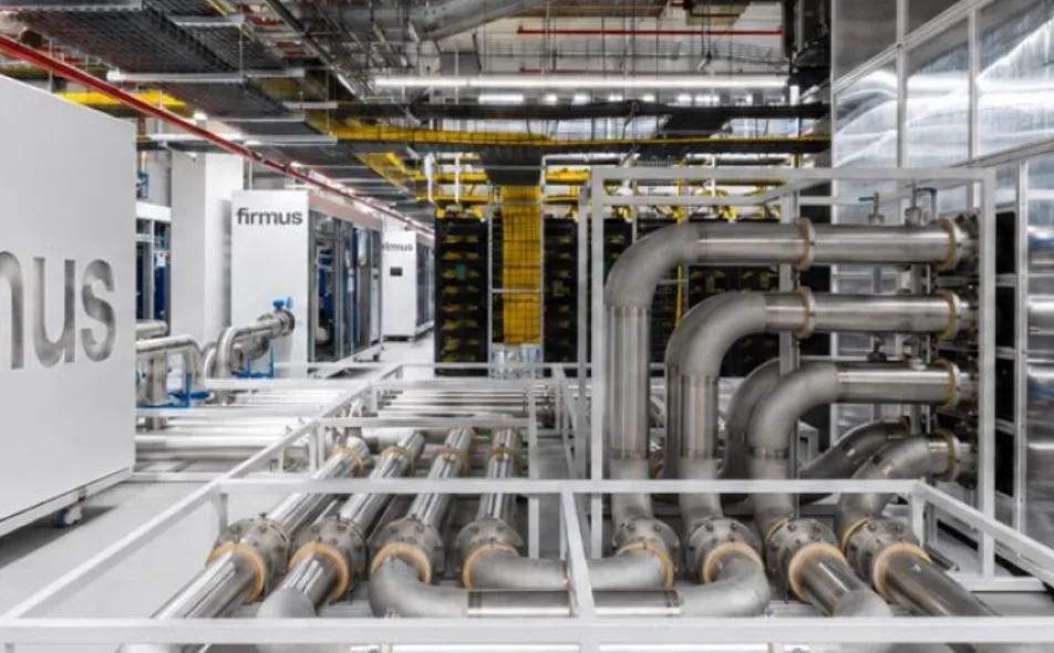 NVIDIA GB300 NVL72 racks inside Firmus's Melbourne AI factory, where Meta runs its AI workloads, with liquid-cooling pipework beneath the racks and yellow cabling overhead